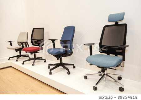 modern chairs with colorful upholstered near beige wall . 89354818