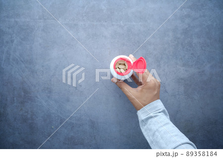 top view of young man hand holding medicine pill container  89358184