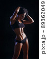 Female fitness model posing on black background 89362049