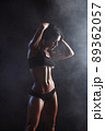 Female fitness model posing on black background 89362057