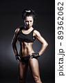 Female fitness model posing on black background 89362062