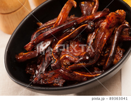 Korean pork ears in black bowl 89363041