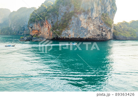 Sea views and rocky islands with a long-tail boat. 89363426