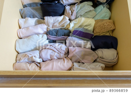 The variety of adult panties in the wooden drawer of the large wardrobe. 89366859