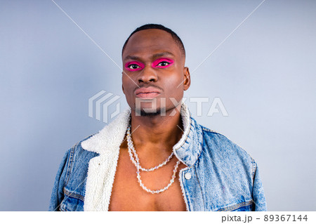 naked torso man with beauty makeup wear Jean jacket over a nude body in studio white background 89367144