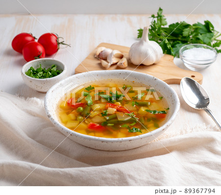 Healthy spring vegetable dietary vegetarian soup, white wooden background, side view, close up Healthy spring vegetable dietary vegetarian soup, white wooden background, side view, close up 89367794