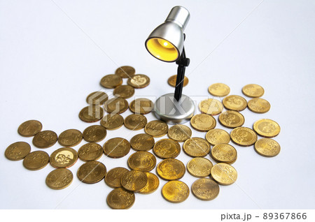 Lamp with gold coins on white background. Business and copy space concept Lamp with gold coins on white background. Business and copy space concept 89367866