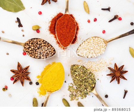 Set of spices in spoons top view. Paprika, curry, Bay leaf, anise and other seasonings 89368015