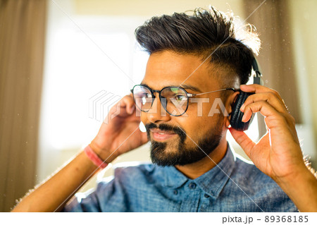 handsome bearded brunette arabian man listen musics intdoor apartment handsome bearded brunette arabian man listen musics intdoor apartment 89368185