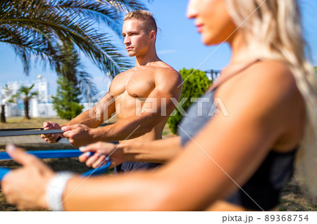 Young couple in sports outfit doing morning workout outdoors in hot summer 89368754