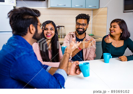 arabian men and women sitting in kitchen and discussing a news arabian men and women sitting in kitchen and discussing a news 89369102