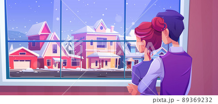 Couple looking at window at snowfall on street 89369232