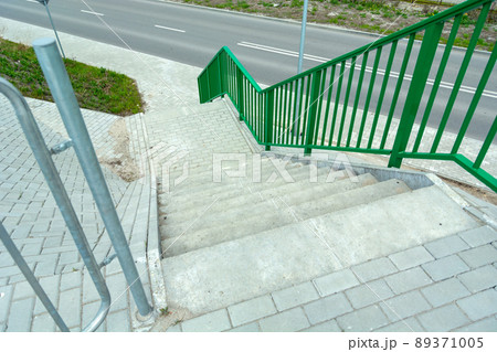 Concrete steps with railing down the street 89371005