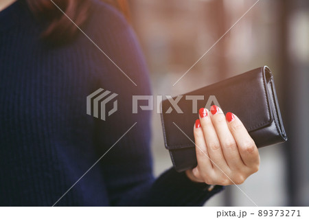 woman person holding a wallet in the hand. Cost control expenses shopping in concept. Leave space to write descriptive text 89373271
