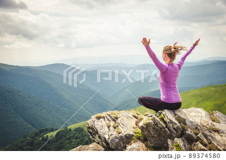 Young woman on the top of mountain 89374580