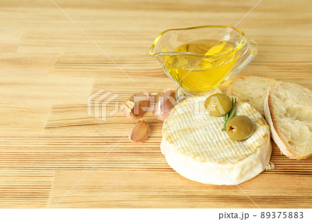 Concept of tasty food with grilled camembert on wooden background Concept of tasty food with grilled camembert on wooden background 89375883