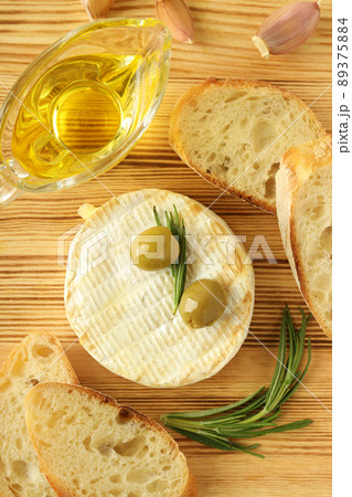 Concept of tasty food with grilled camembert on wooden background Concept of tasty food with grilled camembert on wooden background 89375884
