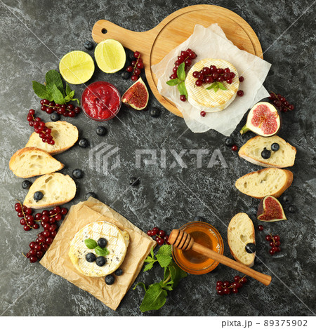 Concept of tasty food with grilled camembert on black smokey background Concept of tasty food with grilled camembert on black smokey background 89375902