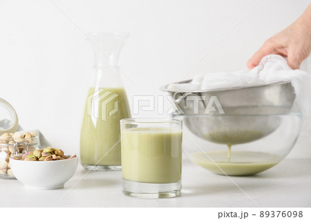 Pistachio milk in glass, lactose free. Vegan alternative plant based milk. Pistachio milk in glass, lactose free. Vegan alternative plant based milk. 89376098
