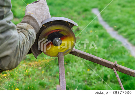 Metal processing with angle grinder sparks in metalworking works Metal processing with angle grinder sparks in metalworking works 89377630