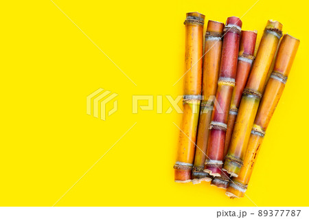 Sugar cane on yellow background. 89377787