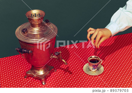 Colorful bright image of old-fashioned kettle called samovar isolated over dark green background. Drinking tea 89379703