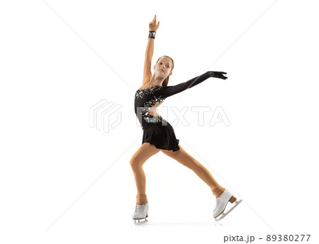Portrait of little flexible girl, figure skating wearing stage attire posing isolated on white studio backgound. Concept of movement, sport, beauty. Portrait of little flexible girl, figure skating wearing stage attire posing isolated on white studio backgound. Concept of movement, sport, beauty. 89380277