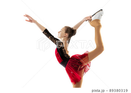 Portrait of little flexible girl, figure skating wearing stage attire posing isolated on white studio backgound. Concept of movement, sport, beauty. 89380319