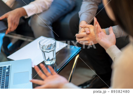 Group of three businesspeople carrying out negotiations indoors 89382480
