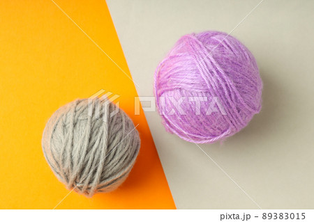 Multi colored balls of yarn on two tone background Multi colored balls of yarn on two tone background 89383015
