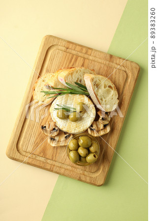 Concept of tasty food with grilled camembert on two tone background Concept of tasty food with grilled camembert on two tone background 89383260