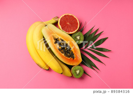 Fresh and ripe exotic fruits on pink background 89384316