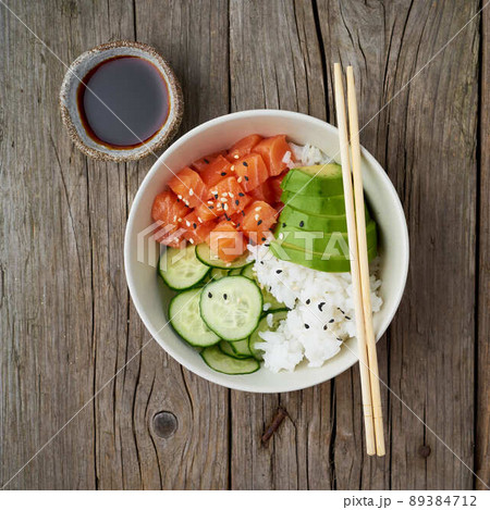 salmon poke bowl with fresh fish, rice, cucumber, avocado salmon poke bowl with fresh fish, rice, cucumber, avocado 89384712