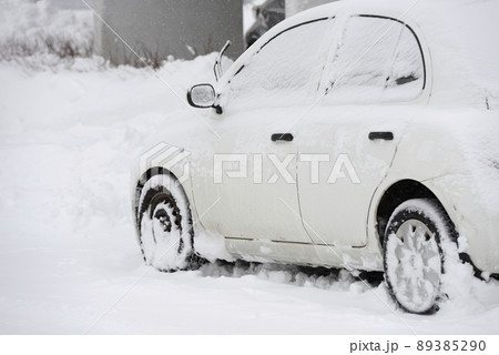 car covered with snow after snowfall 89385290