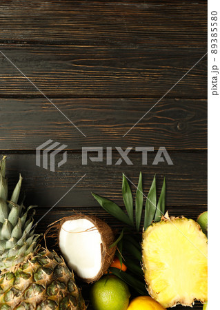 Exotic fruits on wooden background, space for text 89385580
