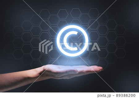 The concept of copyright and intellectual property as a projection of a hologram on the hand. 89386200