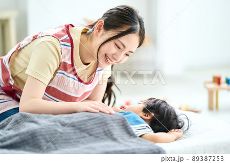 保育園時を寝かしつける女性保育士 89387253