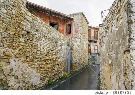 view of a romantic narrow street in a small, partially uninhabited mountain village in Cyprus view of a romantic narrow street in a small, partially uninhabited mountain village in Cyprus 89387355
