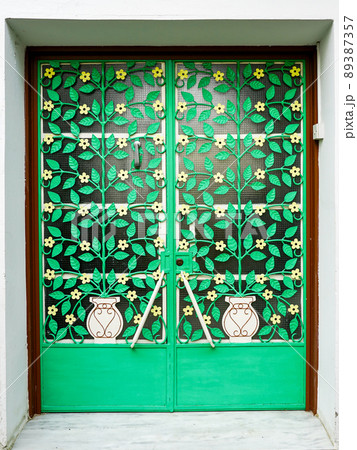 house exterior door with beautiful metal wrought ornaments in the form of a flower pot and flowers house exterior door with beautiful metal wrought ornaments in the form of a flower pot and flowers 89387357