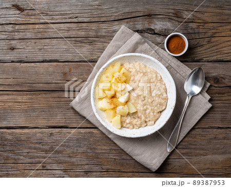 Large bowl of tasty and healthy oatmeal with apple for Breakfast, morning meal. 89387953