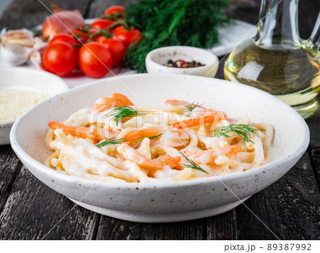 italian pasta spaghetti with shrimps, bechamel sauce and chopped dill italian pasta spaghetti with shrimps, bechamel sauce and chopped dill 89387992