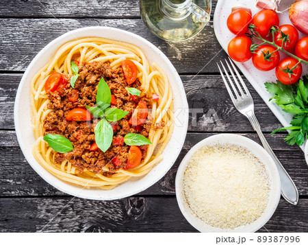 pasta bolognese with tomato sauce, ground minced beef, basil leaves on background pasta bolognese with tomato sauce, ground minced beef, basil leaves on background 89387996