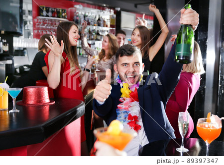 Cheerful guy expressively dancing partying in bar Cheerful guy expressively dancing partying in bar 89397347