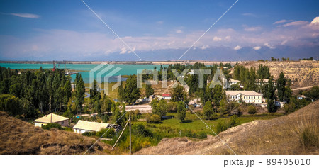 aerial panorama view to Karakol towm, formerly Przhevalsk, and Issyk-Kul lake, Kyrgyzstan 89405010
