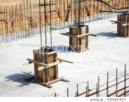 SELANGOR, MALAYSIA -JULY 7, 2021: Column stump formwork that has been installed at the construction site. Steel reinforcement bars are ready to be installed and ready to be poured concrete into it. SELANGOR, MALAYSIA -JULY 7, 2021: Column stump formwork that has been installed at the construction site. Steel reinforcement bars are ready to be installed and ready to be poured concrete into it. 89405493