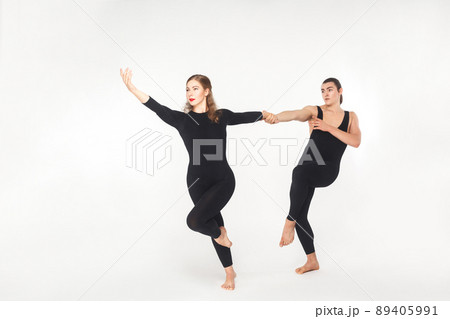 Harmony, partnership. Friends holding hands and dancing. Studio shot, isolated on white background Harmony, partnership. Friends holding hands and dancing. Studio shot, isolated on white background 89405991