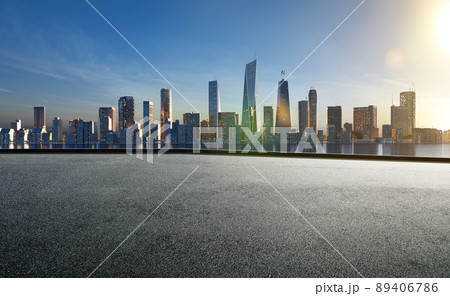 Cityscape skyline evening scene with empty asphalt floor Cityscape skyline evening scene with empty asphalt floor 89406786