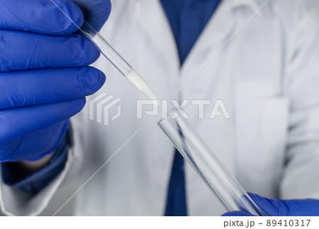 Medical laboratory assistant checks a test tube with sperm. Spermogram. Male fertility test. Semen in a test tube. Reproductive system check. Donor suitability test for artificial insemination 89410317