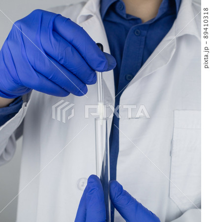 Medical laboratory assistant checks a test tube with sperm. Spermogram. Male fertility test. Semen in a test tube. Reproductive system check. Donor suitability test for artificial insemination Medical laboratory assistant checks a test tube with sperm. Spermogram. Male fertility test. Semen in a test tube. Reproductive system check. Donor suitability test for artificial insemination 89410318