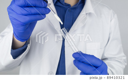 Medical laboratory assistant checks a test tube with sperm. Spermogram. Male fertility test. Semen in a test tube. Reproductive system check. Donor suitability test for artificial insemination Medical laboratory assistant checks a test tube with sperm. Spermogram. Male fertility test. Semen in a test tube. Reproductive system check. Donor suitability test for artificial insemination 89410321